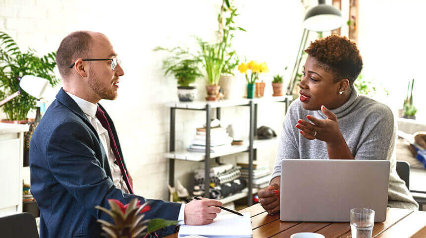 Woman discusses with financial advisor