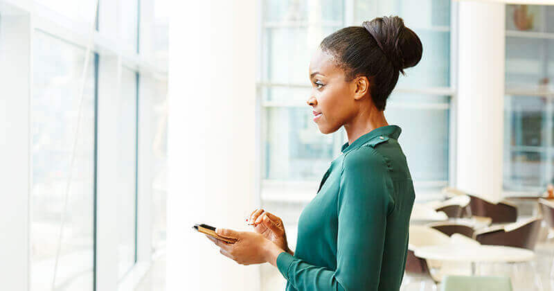 woman looking out window at city