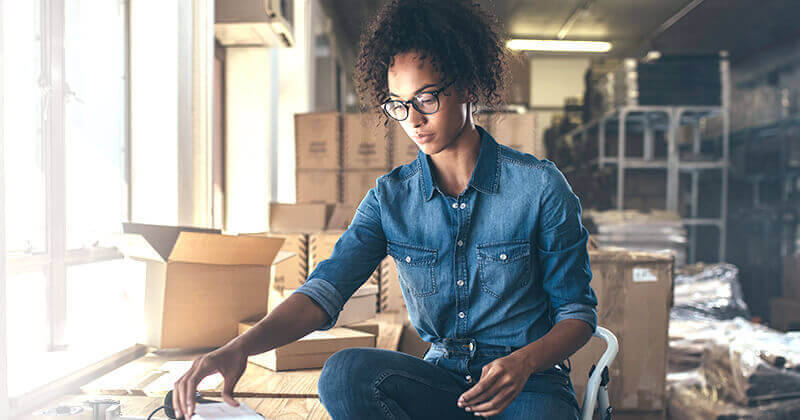 Woman packaging box for delivery