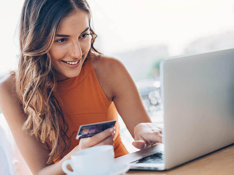 Woman with credit card and laptop