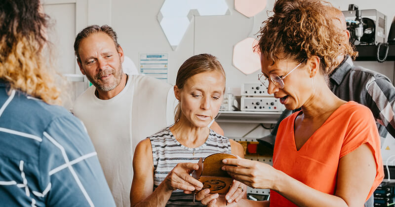 women-discussing-over-item-workshop