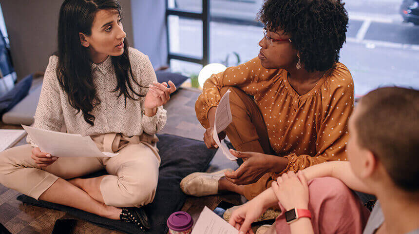 Women working together and using laptop