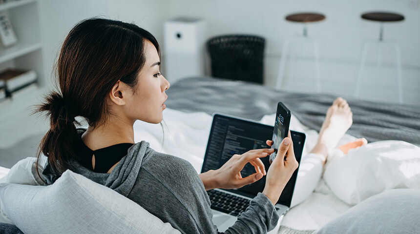 Woman working from home looking at phone