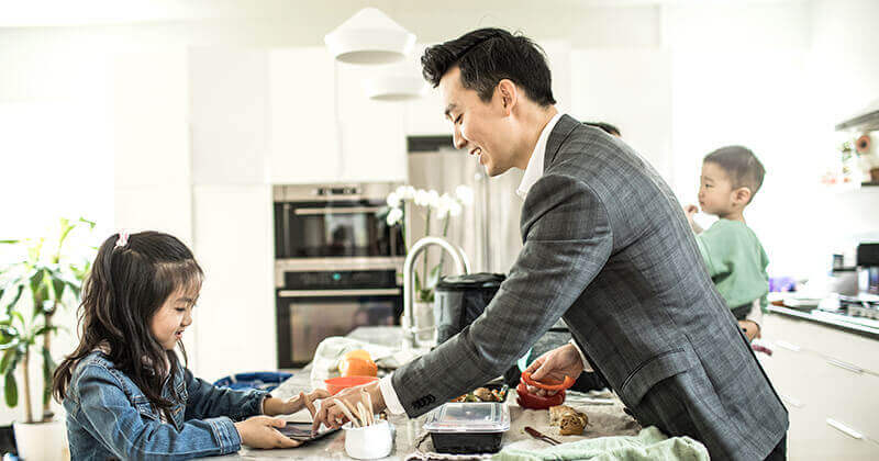 Working parents packing lunches