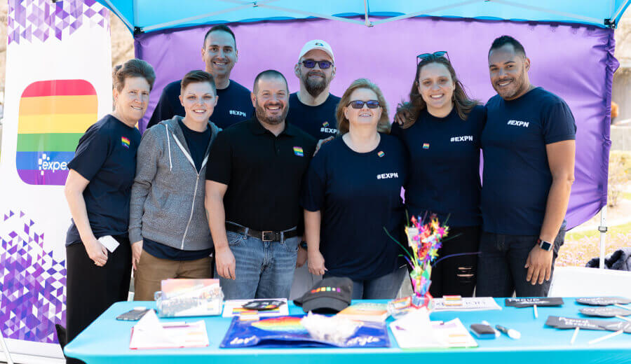 Group of Experian employees at a booth during a Pride event