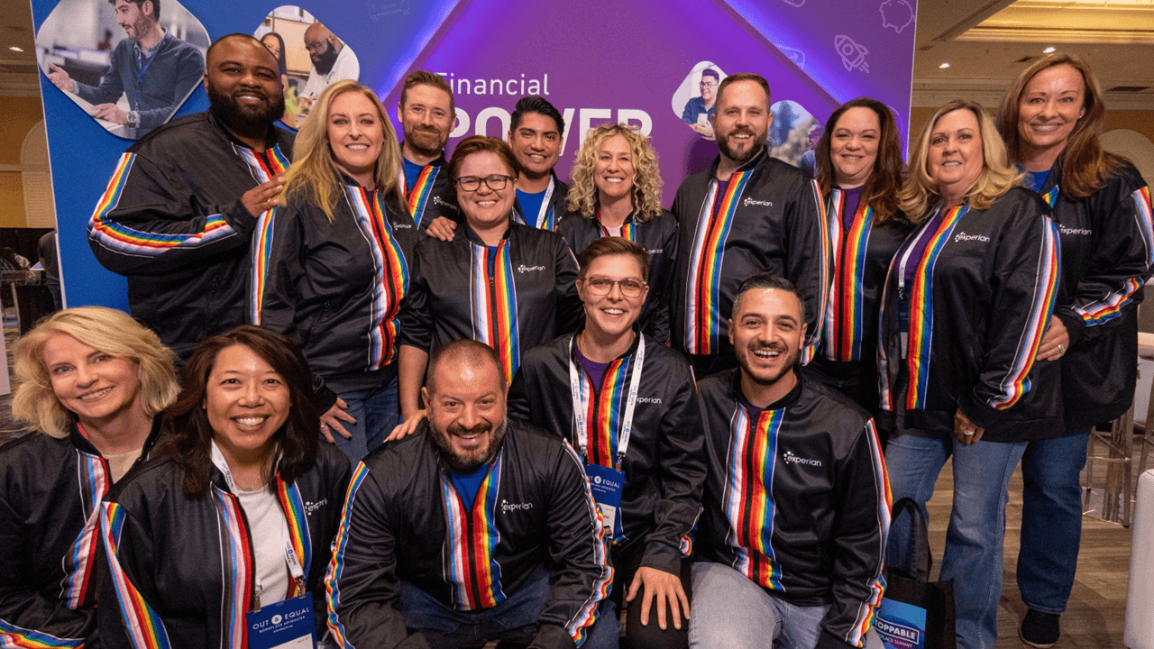 Group of Experian employees at a booth during a Pride event