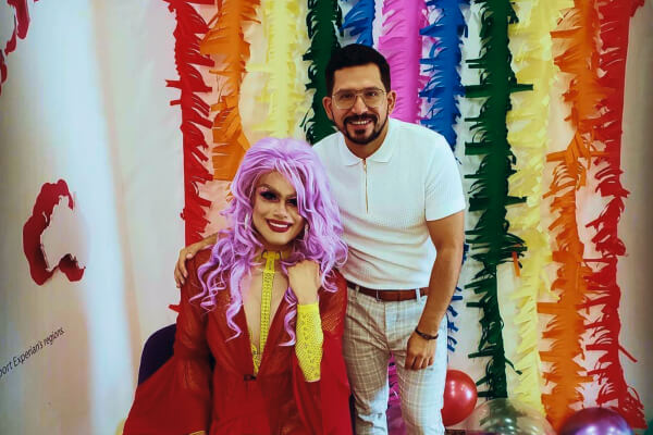 Carlos posing next to a Drag Queen 