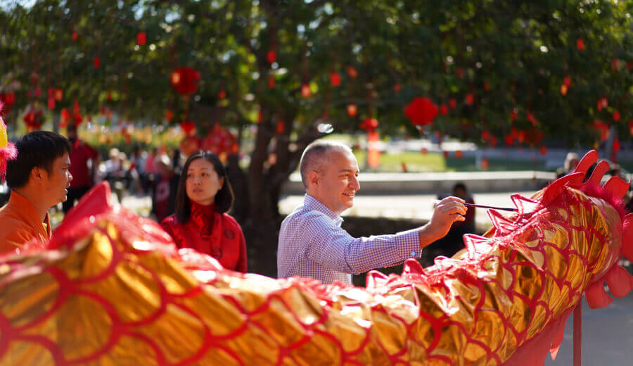 Craig Boundy, Experian NA CEO dancing with a traditional Chinese dragon at an Experian ERG event