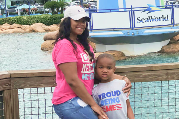 Deja stands with her son at SeaWorld.