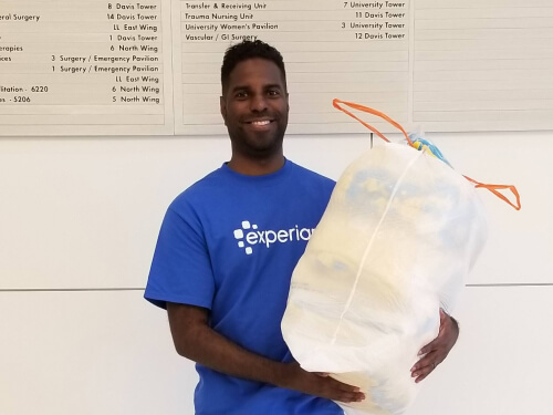 Alfred Raman, an Experian employee volunteering by picking up trash