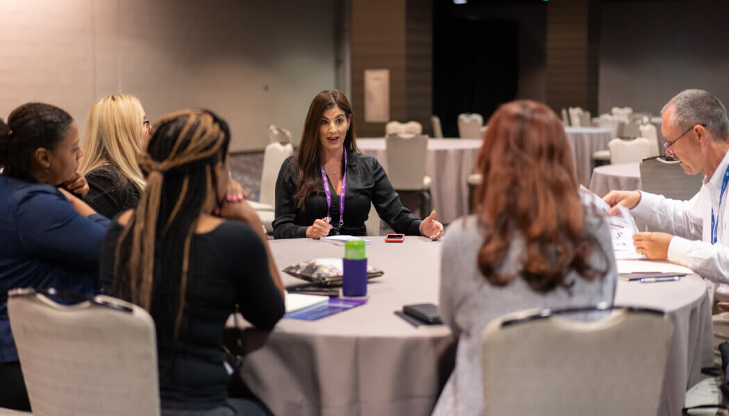 A diverse group of leaders at Experian at a diversity training seminar