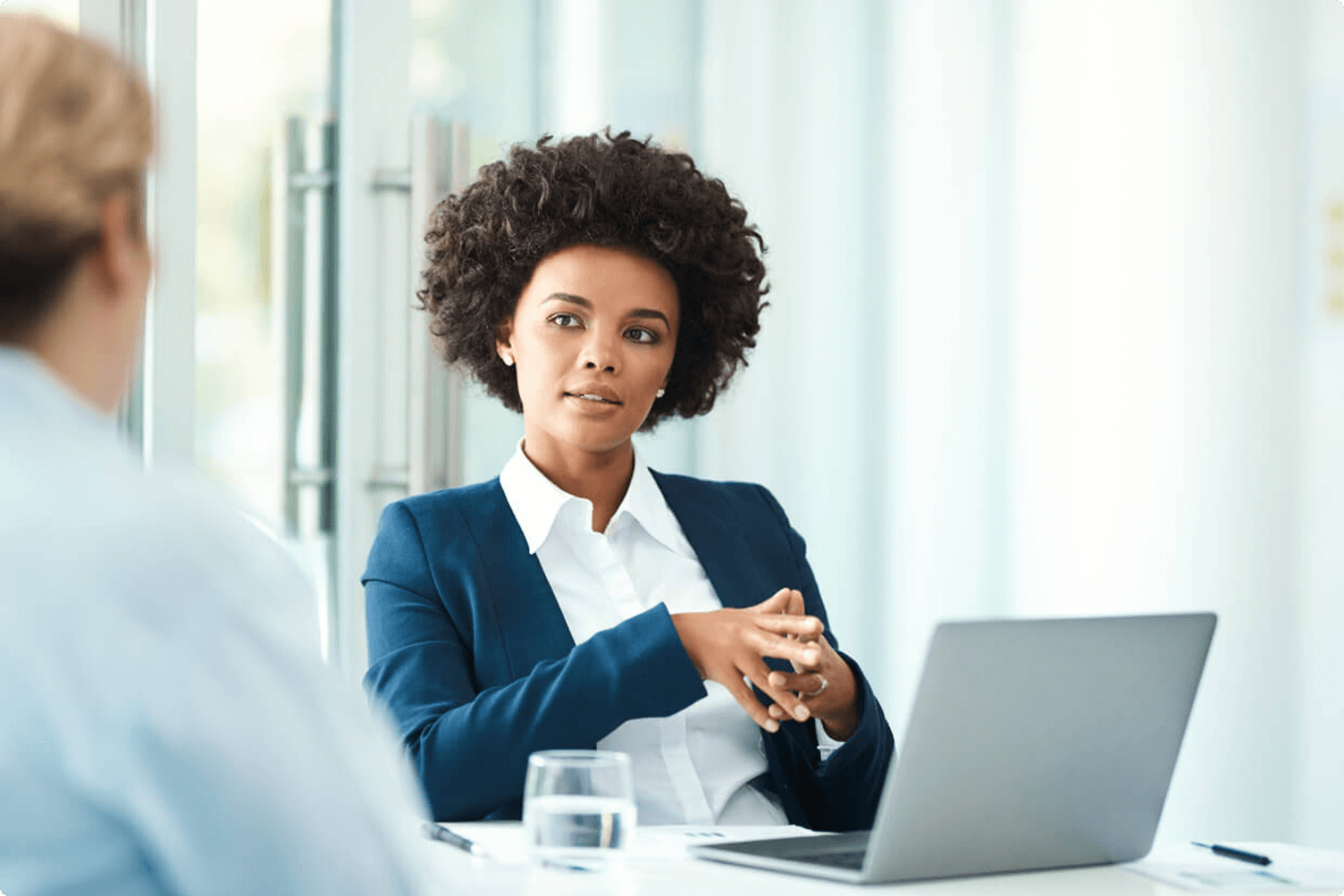 Shot of a businesswoman using her laptop while meeting with a client