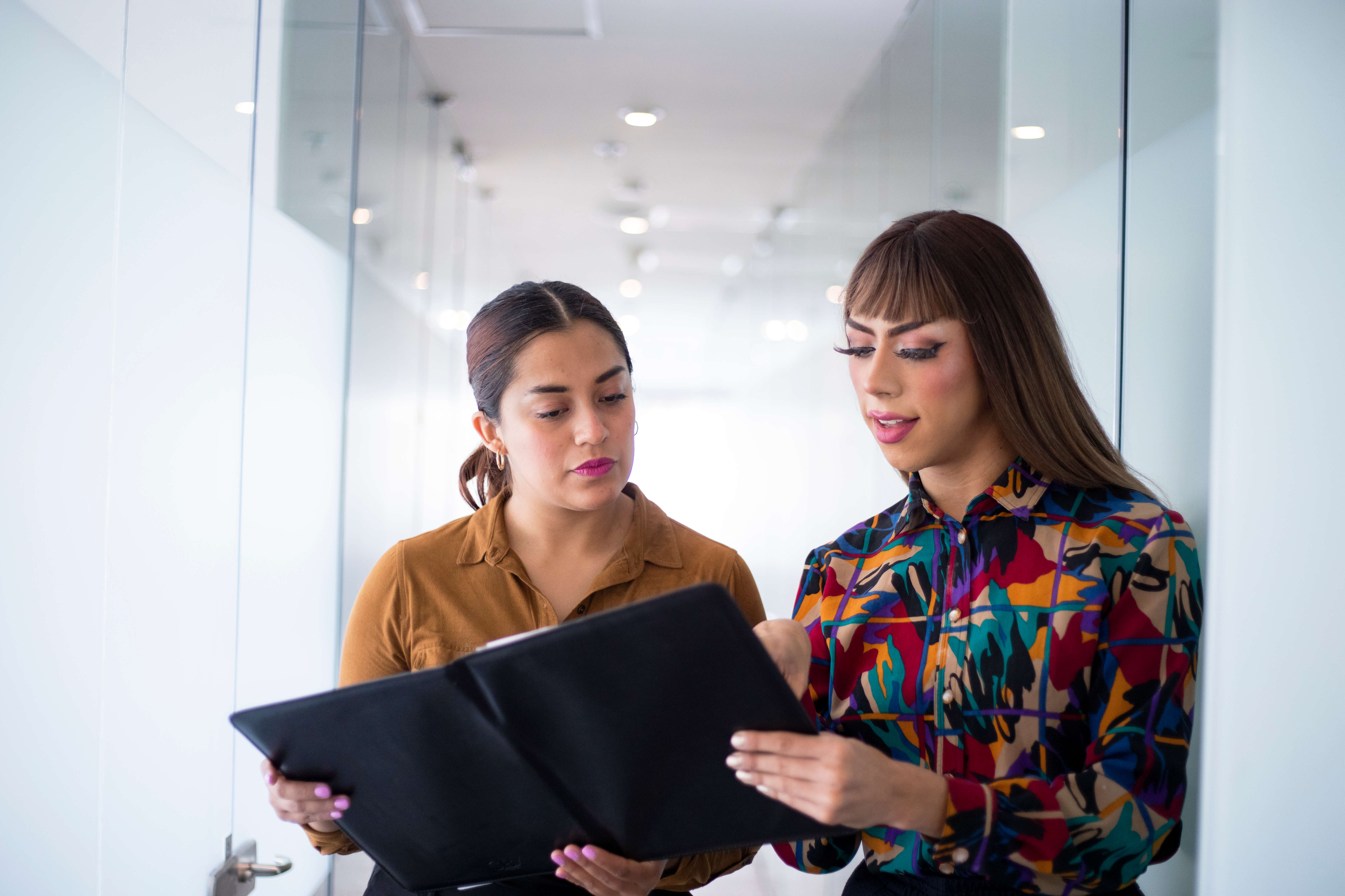 young woman and trans woman in the office