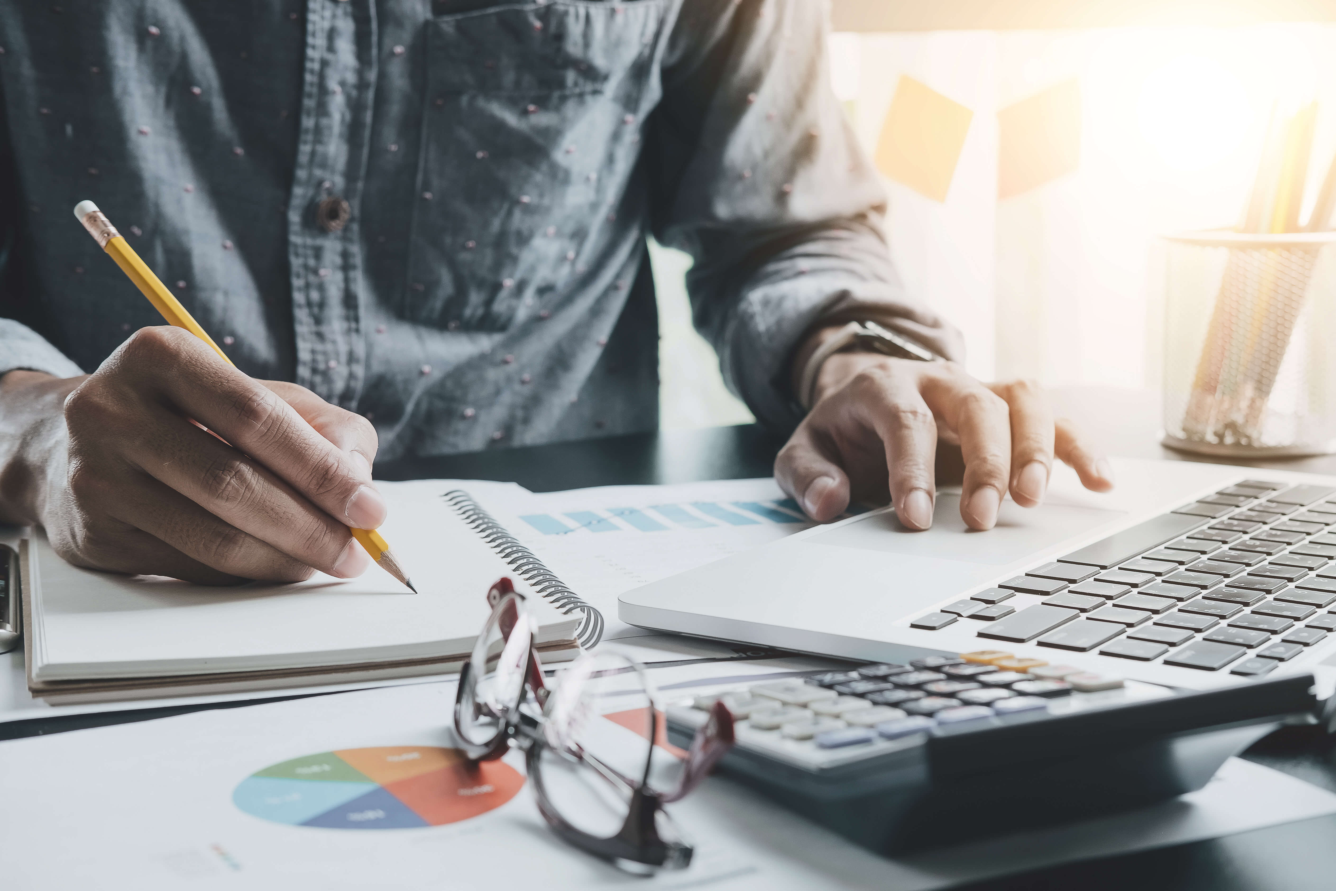 person working at desk with data charts 