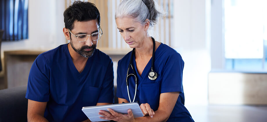 doctor and nurse looking at a patient chart