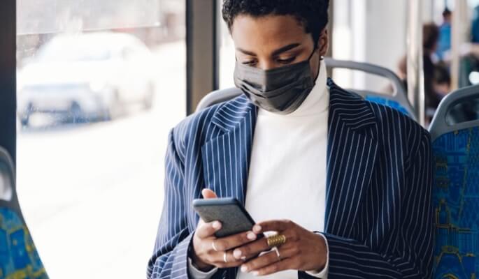 woman using cell phone on bus