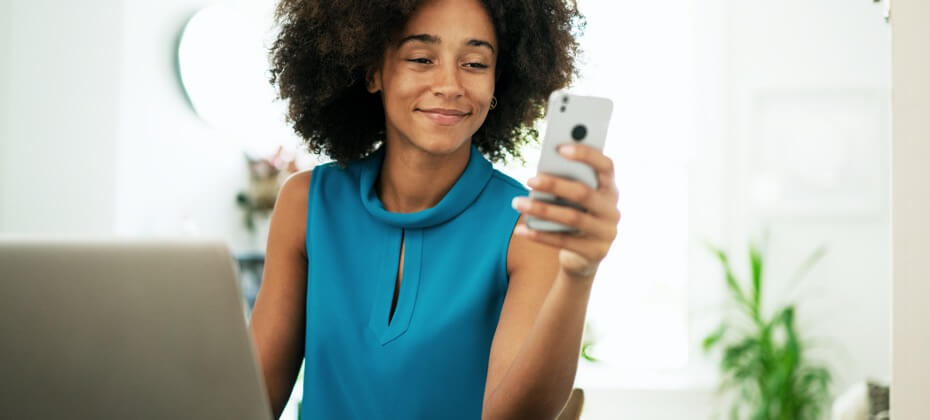 woman looking at cell phone smiling