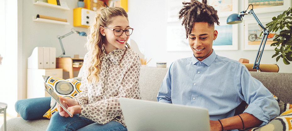 Two individuals looking at a computer screen