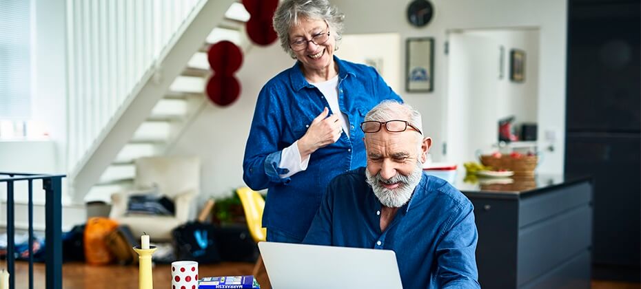 man and woman looking at computer