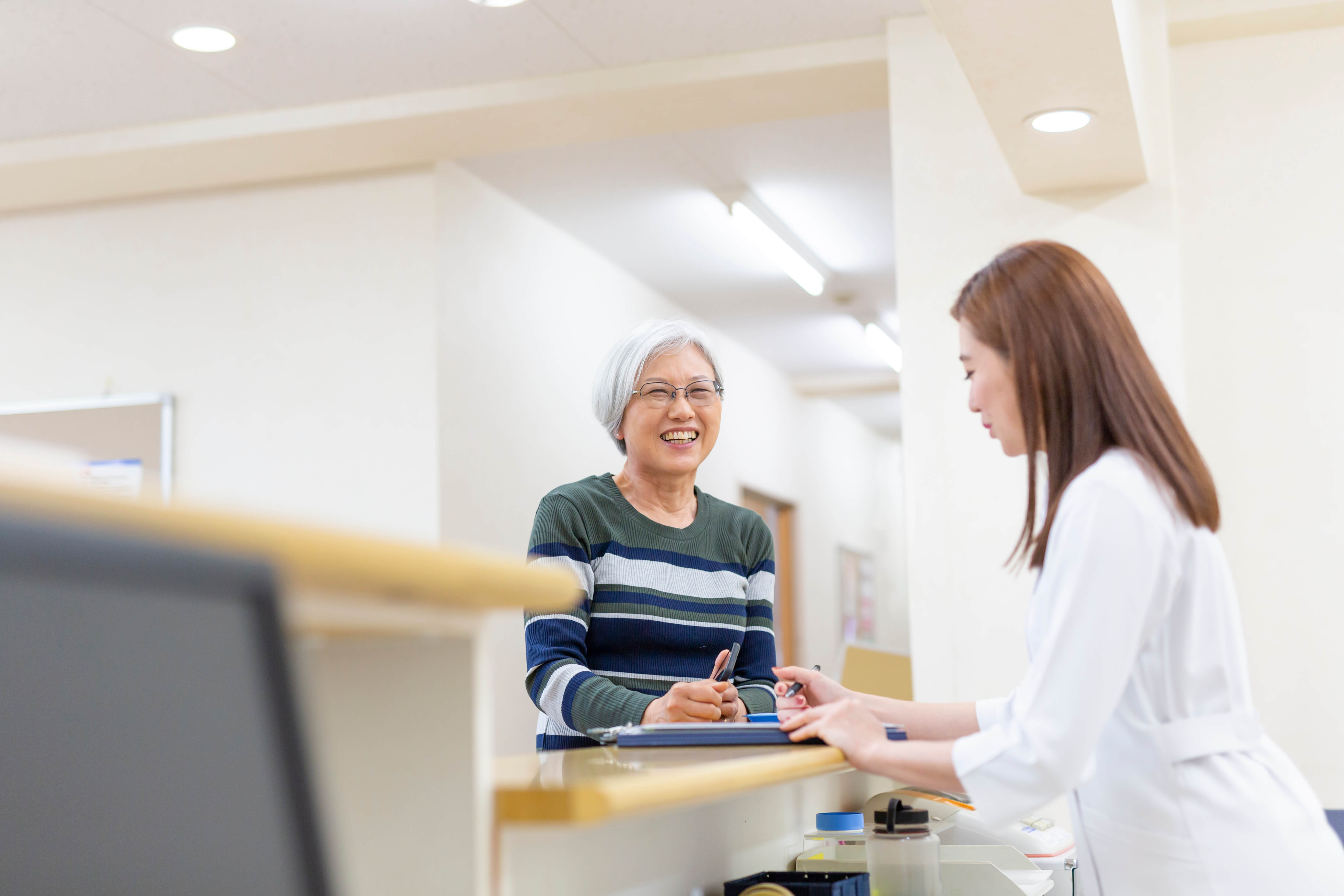 doctor chatting with patient at desk