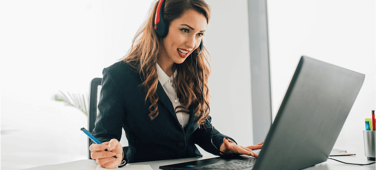 woman wearing headset looking at computer