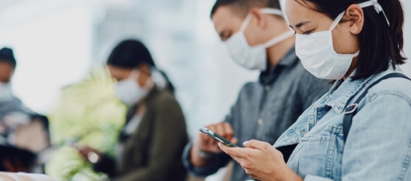 woman-wearing-mask-looking-at-cellphone