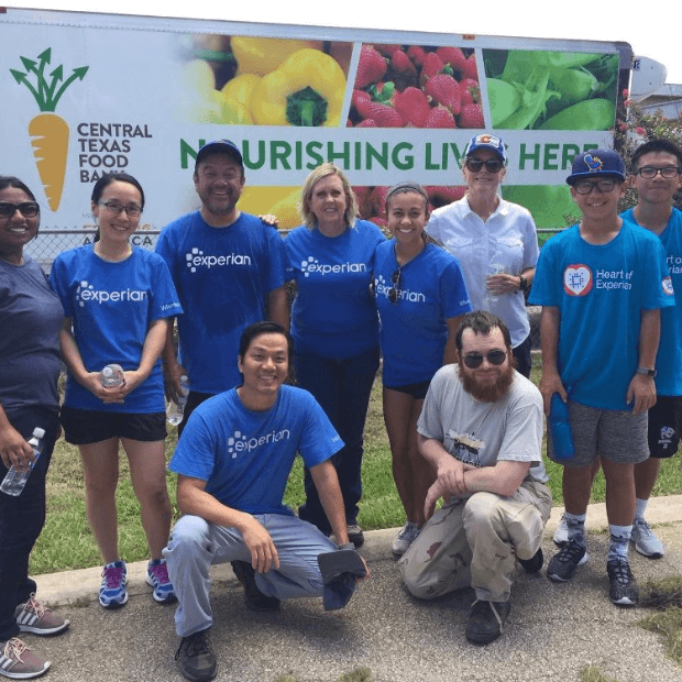 9 of 20 logos - People in Experian t shirts at a food bank